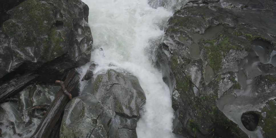 A stream has very rough waters with large rocks