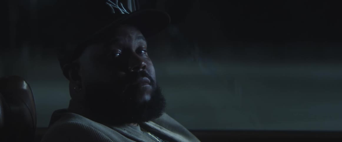 A man is sitting in his car during the night time
