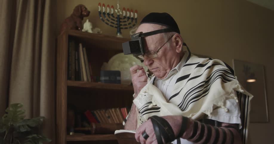 A man is praying with a holy book