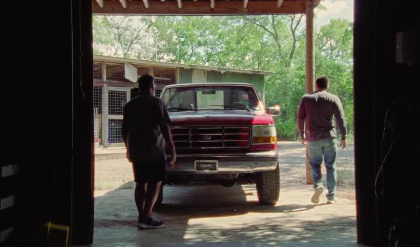A father and son closing the hood of a truck hugging and then the song gets in the truck