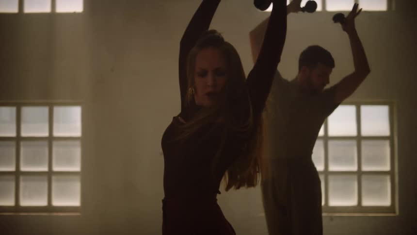 People are dancing together in the dark