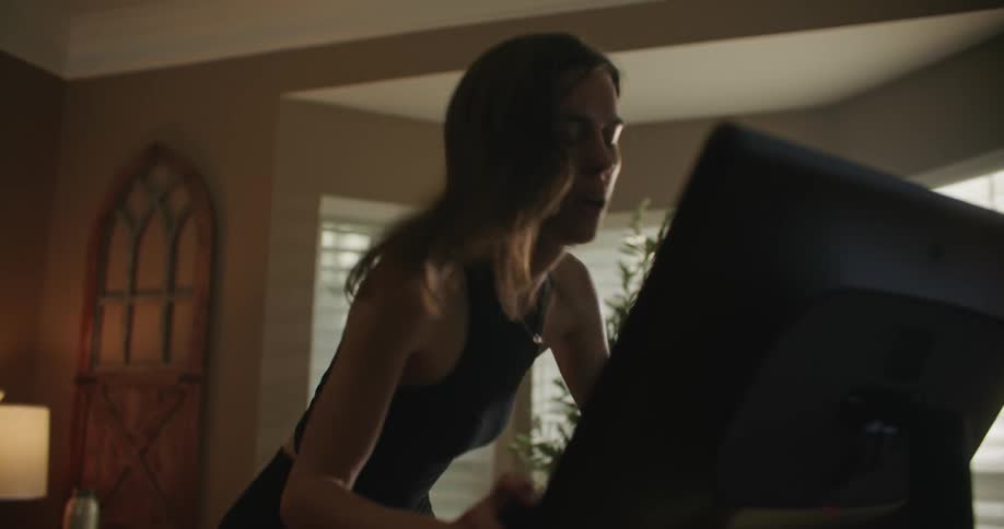 A woman is exercising on a cardio machine