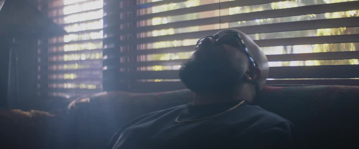 A man is sleeping on the couch