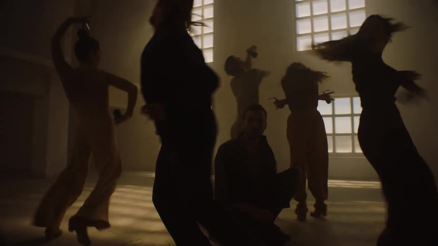 People are dancing around a man