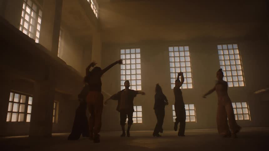 People are dancing in a hall with visible effort and intensity their movements require significant physical exertion and coordination showcasing their dedication and passion for dance