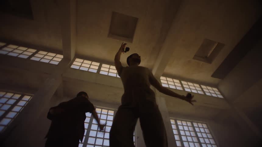 Two men are dancing in a room together