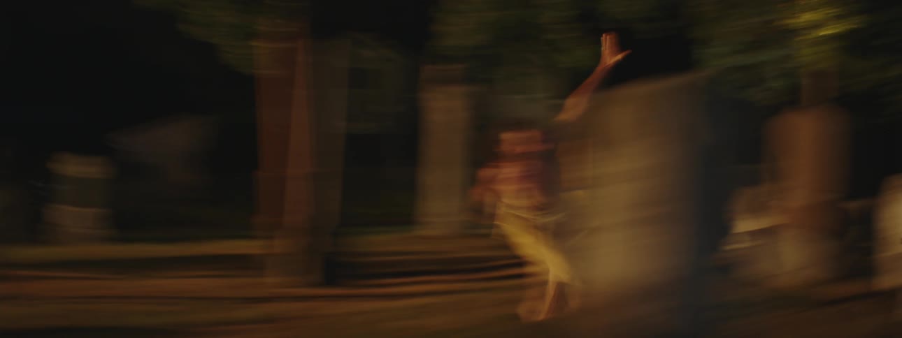 Someone is running in a playful manner through a forest the individual is embracing the natural surroundings experiencing a sense of joy and freedom within the serene environment