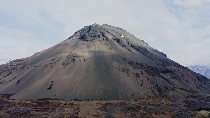 A landscape view of a tall mountain in the wilderness