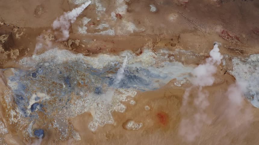 Top down aerial view of geysers on a desert landscape at daytime
