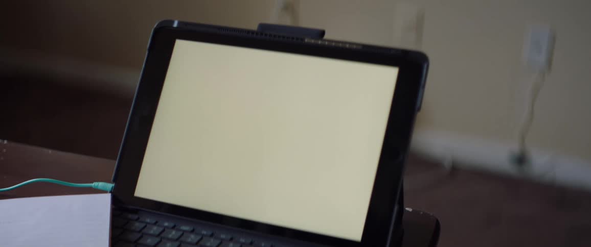 White screen on a laptop over a table inside a room