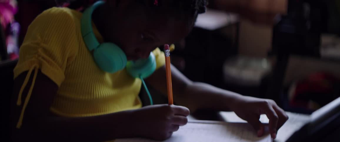 A young girl does school work