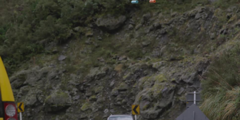 Drone hovering above a moving vehicle
