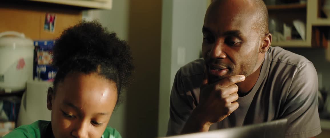Father and daughter distance learning in the kitchen