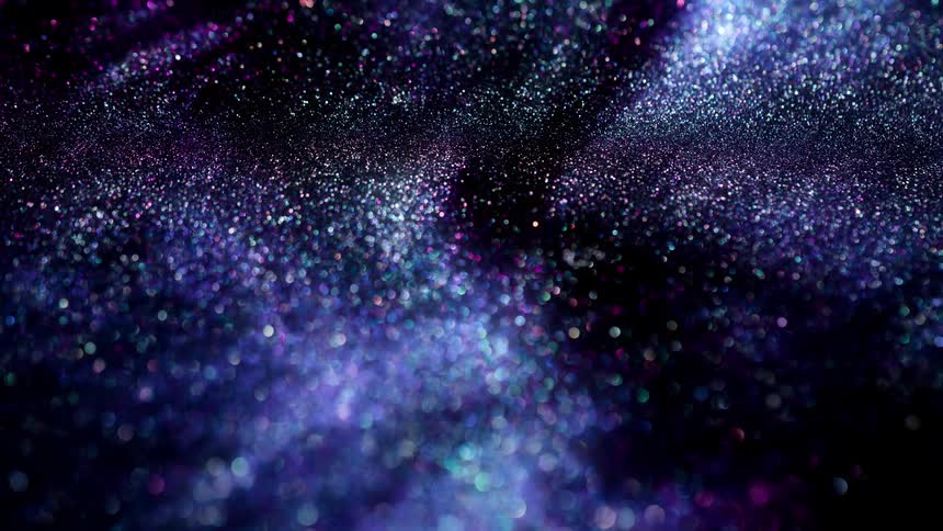 A dark purple substance moves and light shines on the sparkles