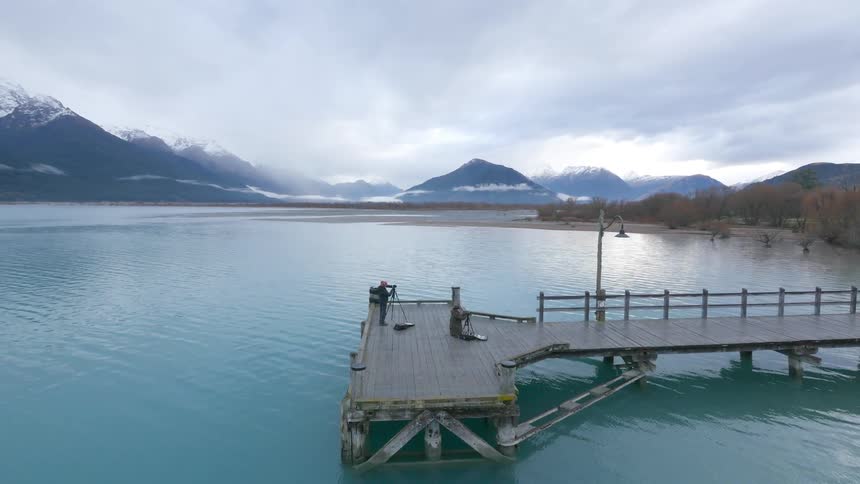 People taking photographs from a dock