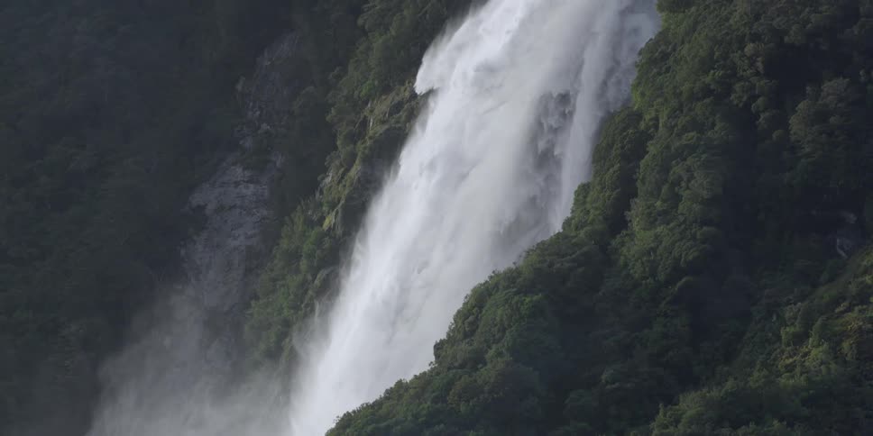 A waterfall on a forested mountain