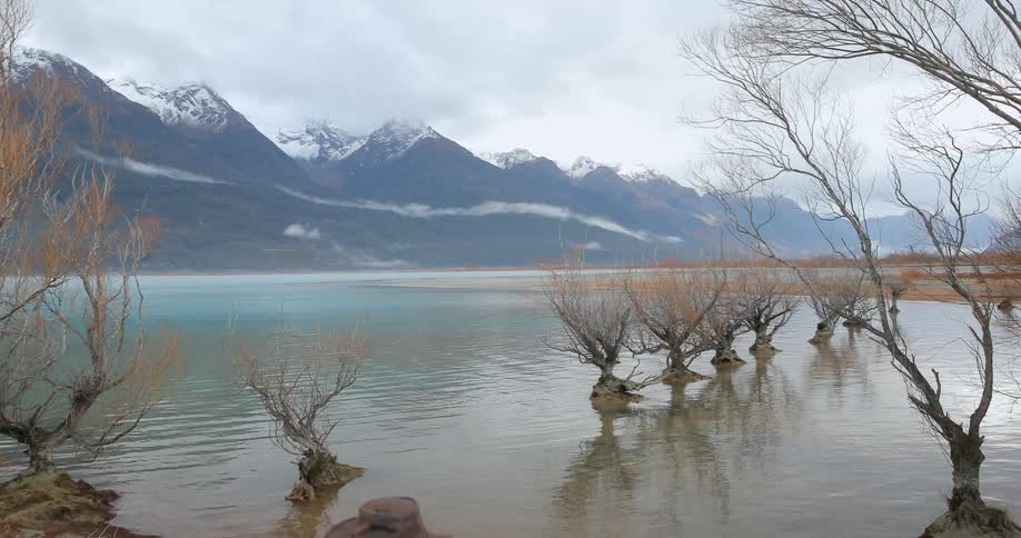 A man points his camera at a lake