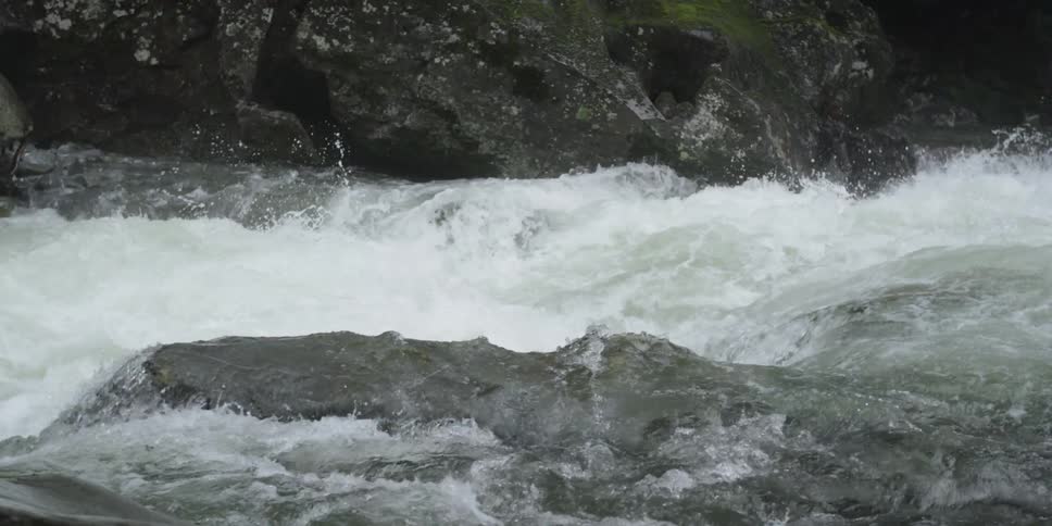 The water in this stream is rough pouring over rocks