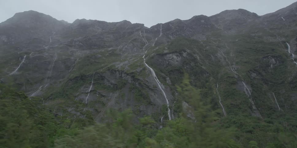 A tree covered mountain on a cloudy day