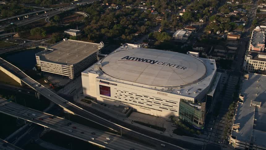 The aerial footage captures a sunrise flyover of Lake Eola and approaching office buildings the Amway Center arena and Downtown Orlando in Central Florida