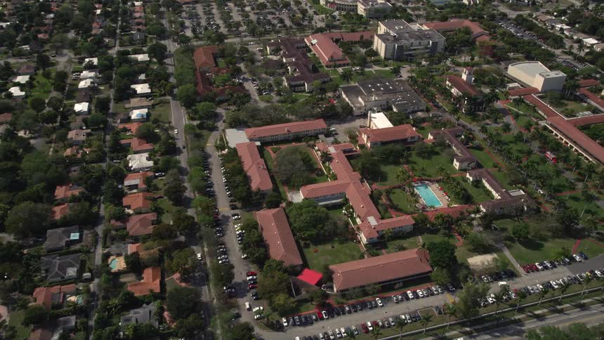This is an aerial view footage of Barry University in Miami Shores Florida showcasing the campus buildings and surroundings on a sunny day