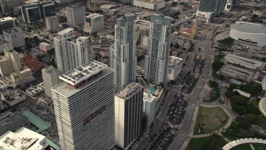 An aerial view of skyscrapers in Downtown Miami against a partly cloudy sky