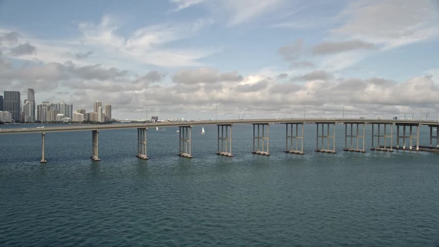 Aerial view of Rickenbacker Causeway with light traffic revealing downtown Miami skyline over Biscayne Bay in South Florida