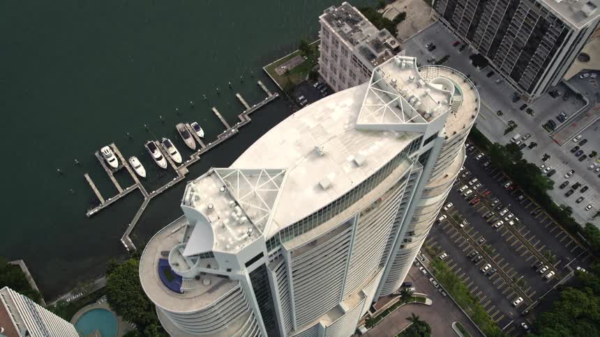 Approaching the Santa Maria high-rise in Downtown Miami this aerial footage captures the stunning coastline and harbor of the city