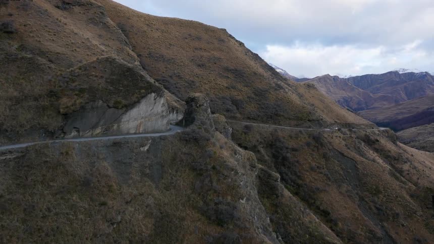 A small road lines the side of this mountain
