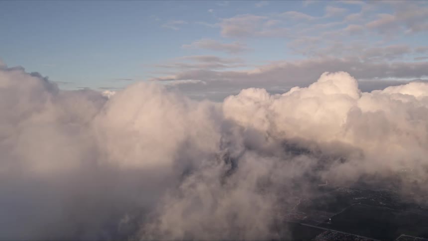 Aerial view of cloudy Florida skyline during sunset as the camera pans left