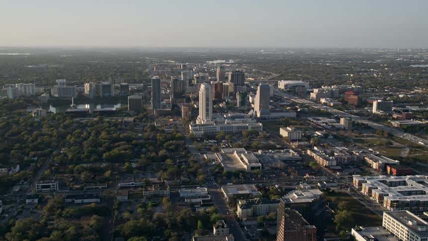 Aerial view of Downtown Orlando at sunrise surrounded by suburbs and large highways