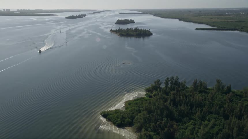 A stunning aerial view of mangroves on the Indian River in Florida while approaching a fishing boat