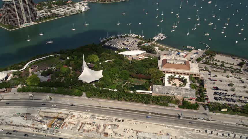 A stunning 5K aerial view of Jungle Island Zoo surrounded by sailboats in the bay on Watson Island Florida