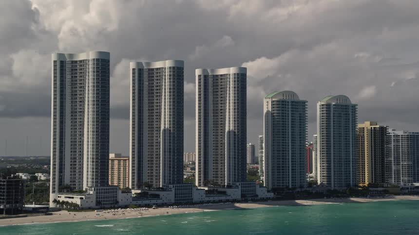 Aerial view of Trump Towers skyscrapers on a cloudy day overlooking the coastline of Sunny Isles Beach Florida