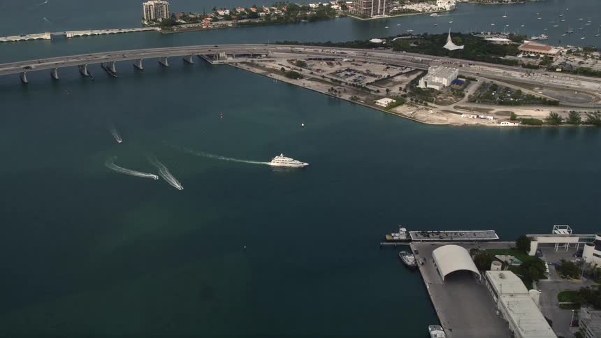 An aerial approach of a yacht cruising the bay by Watson Island Florida on a partly cloudy day
