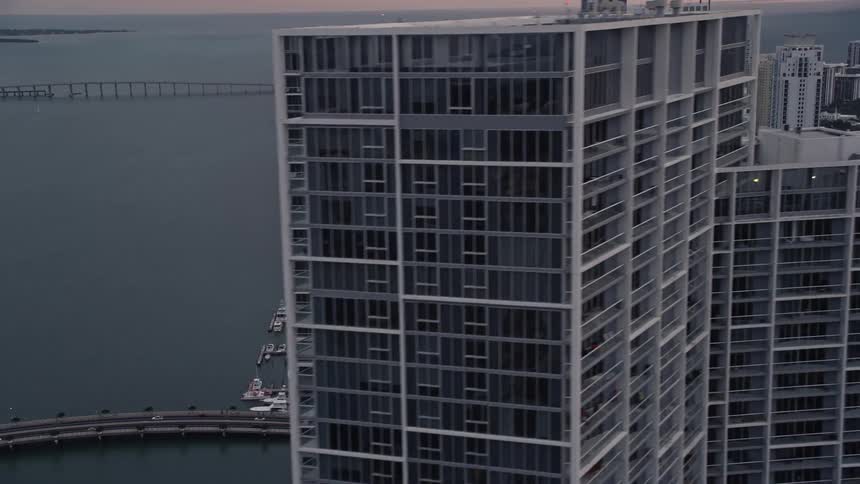 A stunning 5K aerial view of Downtown Miamis bayfront skyscrapers at sunset showcasing Icon Brickell and the metropolitan areas of Southern Florida