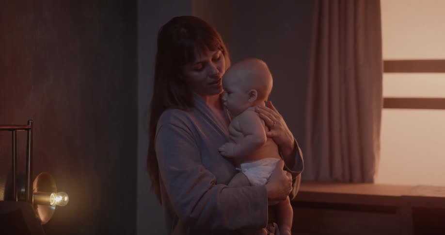 A mother is holding her baby