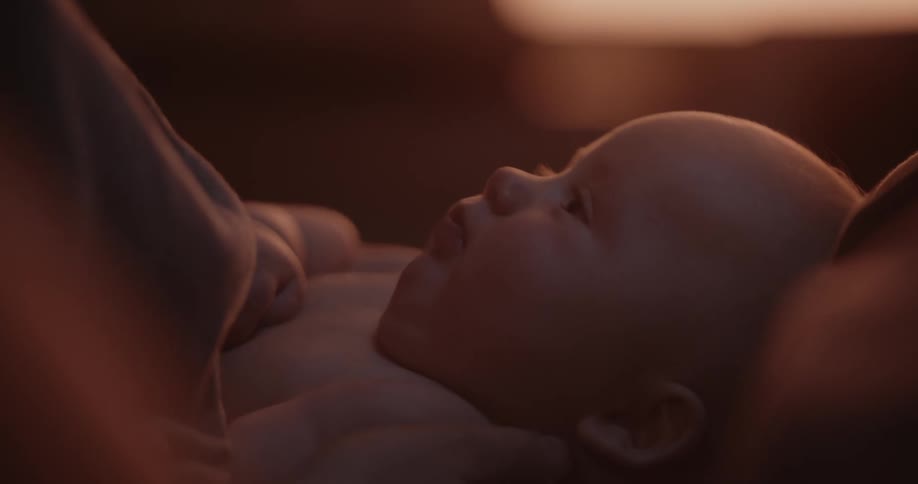 A smiling bald newborn baby