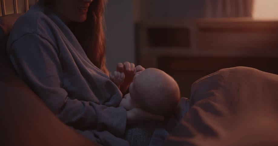 A mother is talking to her son in bed