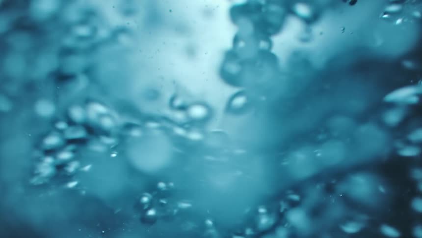 Bubbles flow through bluish water