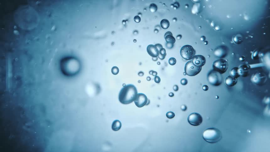 Close up view of water and droplets is displayed