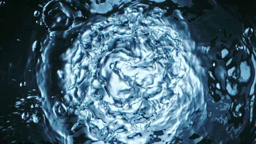 Water forms concentric rings as it splashes and flings drops