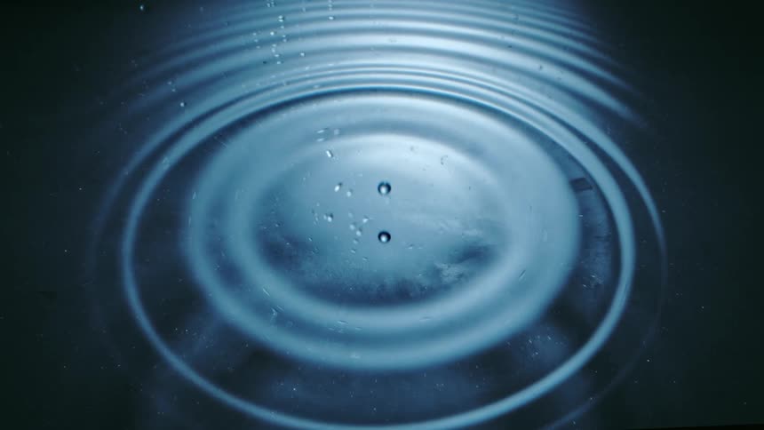 Droplets falling into water and causing ripples