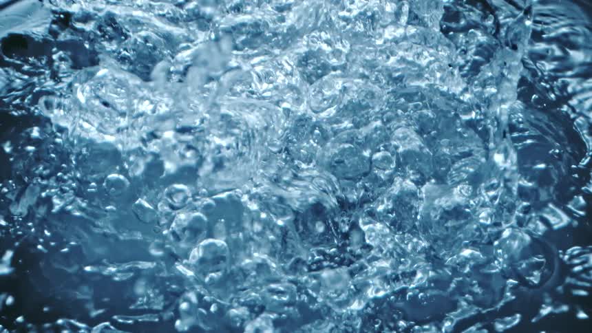Top down close up of clear water rippling and splashing towards the camera