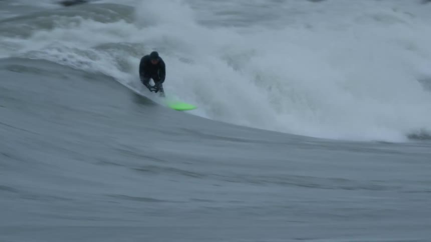 A man rides a large wave
