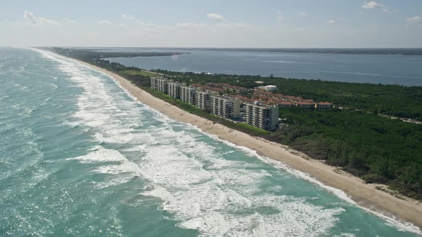 Approaching beachside apartment buildings in Port St Lucie Florida on a sunny day from an aerial view