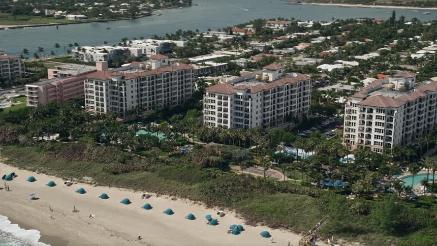 Aerial view of Marriotts Ocean Point hotel and beachgoers enjoying sunshine and recreation in Palm Beach Shores Florida