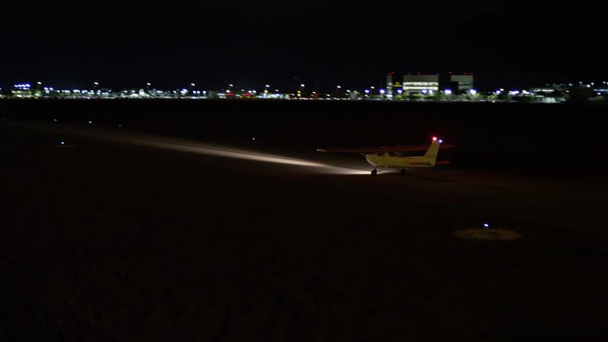 A small plane waits at Kendall-Tamiami Executive General Airport at night in Florida captured in clear 5K aerial view footage