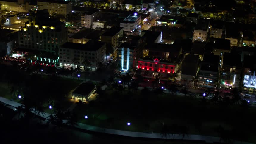 An aerial view of illuminated hotels on Ocean Drive in South Beach Florida at night perfect for sightseeing and travel enthusiasts