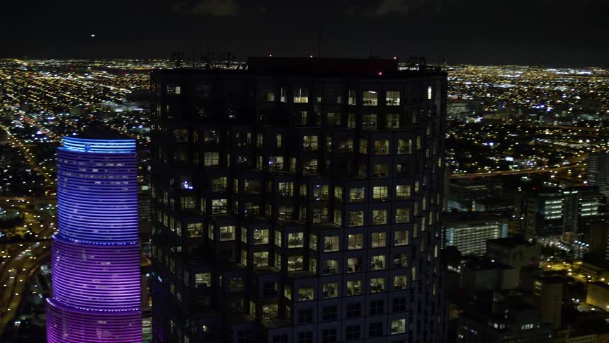 Approaching and orbiting the Southeast Financial Center this aerial footage showcases the stunning high-rise towers of Downtown Miami at night